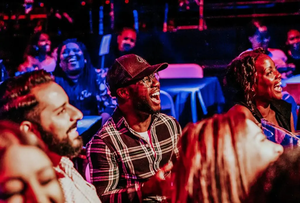 A group of people sitting in front of a crowd.